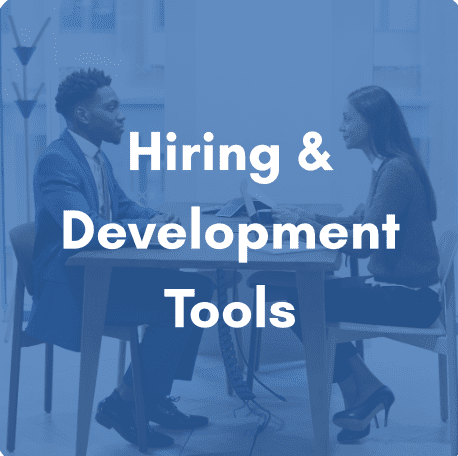 Image shows two people sitting at a desk. The image has been darken with a blue hue with the statement "Hiring & Development Tools" overlayed.